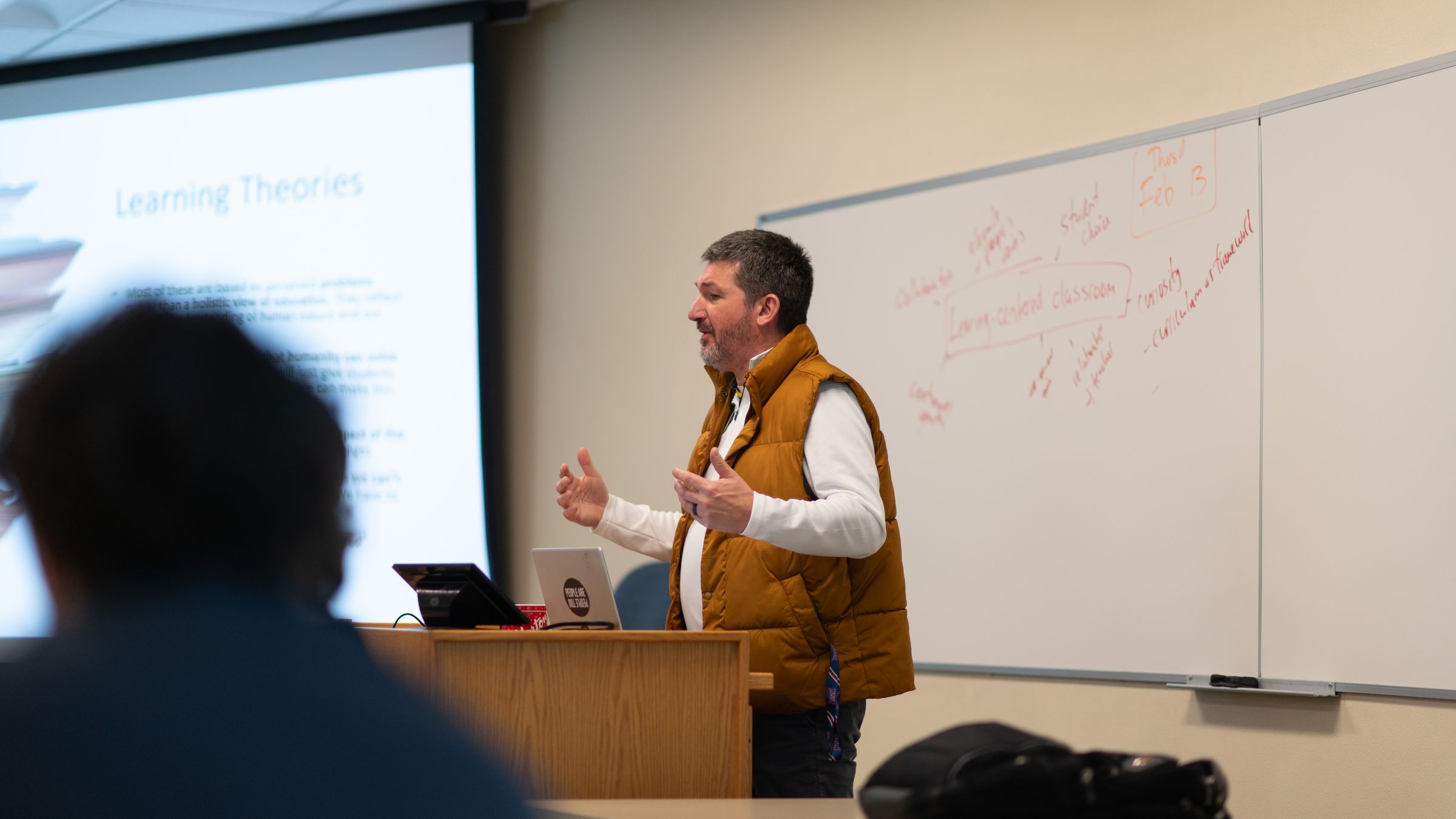 Matt Beimers teaching in front of a whiteboard at Dordt University