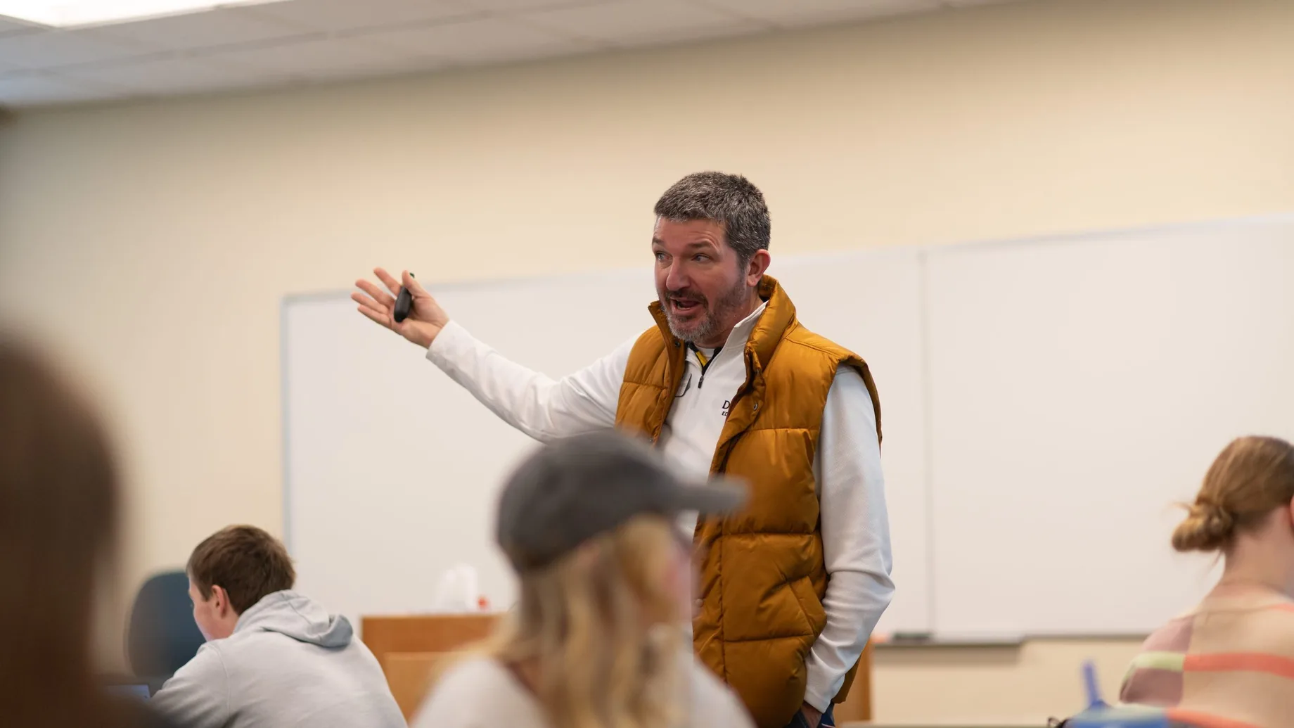 Matthew Beimers gesturing as he explains something to a class