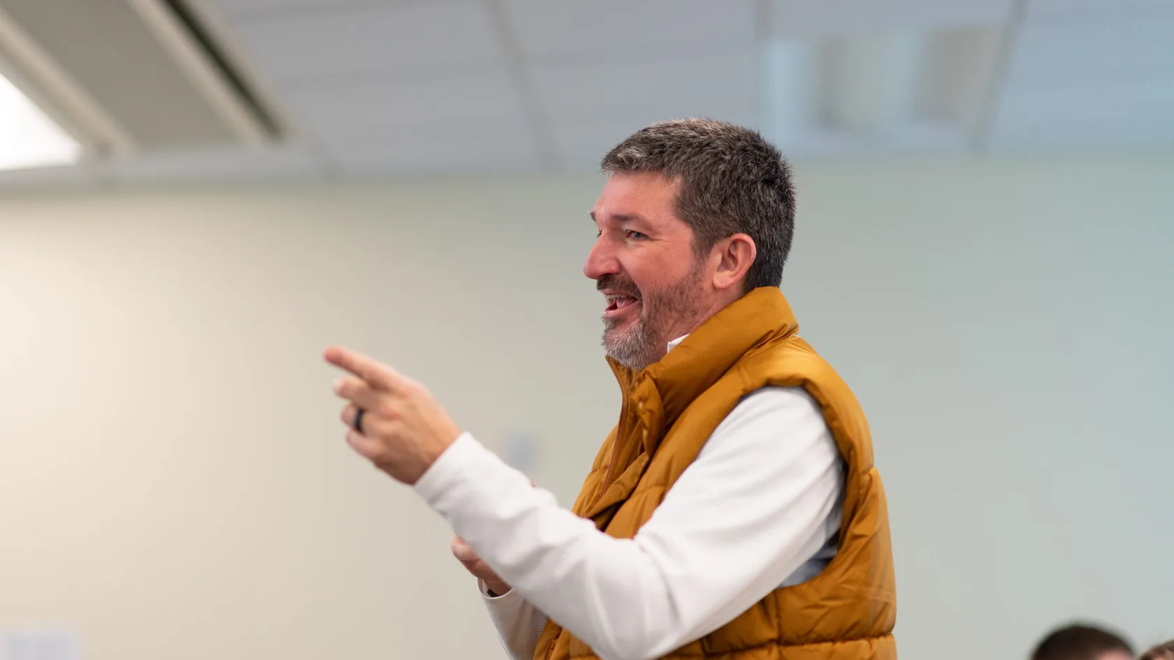 Matthew Beimers mid-gesture as he teaches a class, smiling